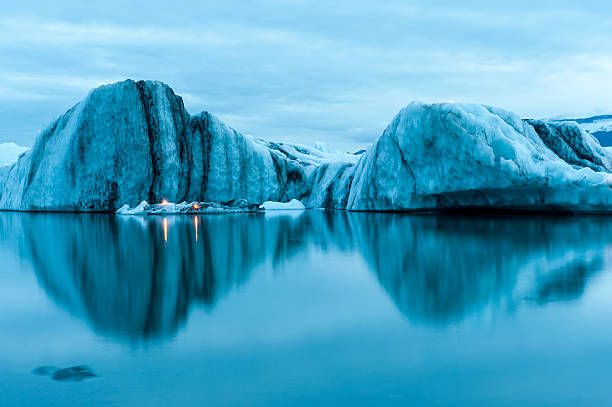 Icebergs with candles, Jokulsarlon ice lagoon, annual firework show, Iceland Icebergs with candles, reflecting in the water, Jokulsarlon ice lagoon before annual firework show, Iceland jokulsarlon stock pictures, royalty-free photos & images