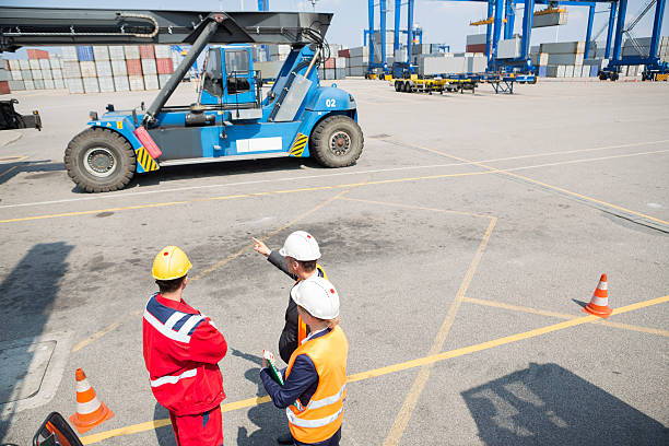 istock High angle view of workers discussing in shipping yard 518730301