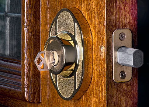 Deadbolt lock on mahogany front door.