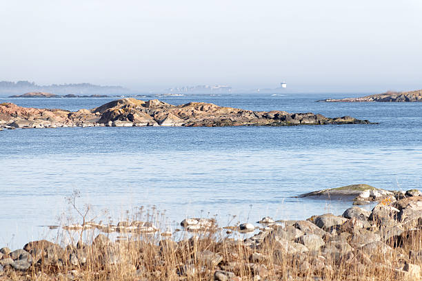 istock Coast, cliffs, distant beacon surrounded with fog sunny day 518730664