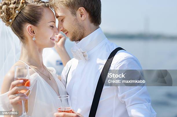 Happy Bride And Groom Drinking Champagne Stock Photo - Download Image Now - Champagne, Kissing, Aboard