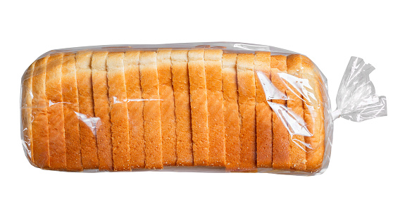 Side and front view of basic turkey sandwich with lettuce on brown bread in plastic baggie. White background.