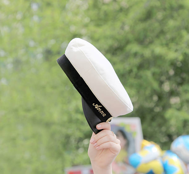 white graduation cap, hand and arm of celebrating graduation stu - studenter sweden bildbanksfoton och bilder
