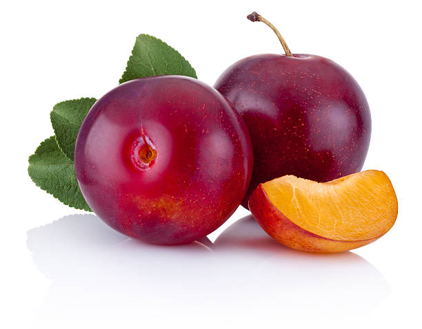 istock Fresh plums with leaves isolated on white background 518737178