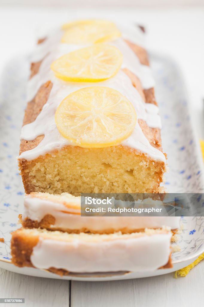 Lemon pound cake Lemon cake with icing decorated with lime slices Lemon - Fruit Stock Photo