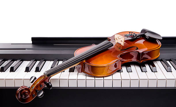 istock The violin lies on keys digital piano 518738916