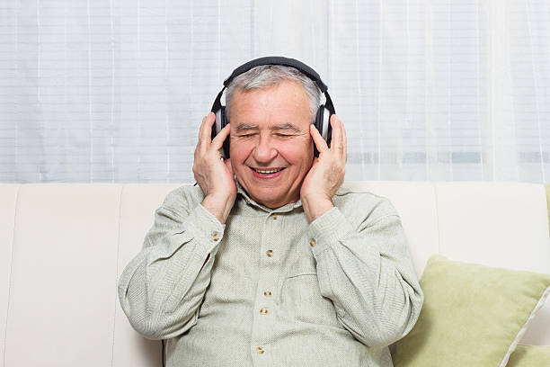 istock Senior man  listening music 518739192
