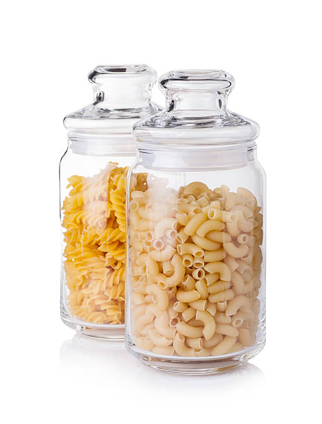 istock Raw macaronies in a glass jar on a white background 518740536