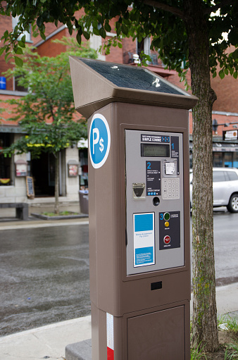 Close up on an electronic parking meter pay station on the street
