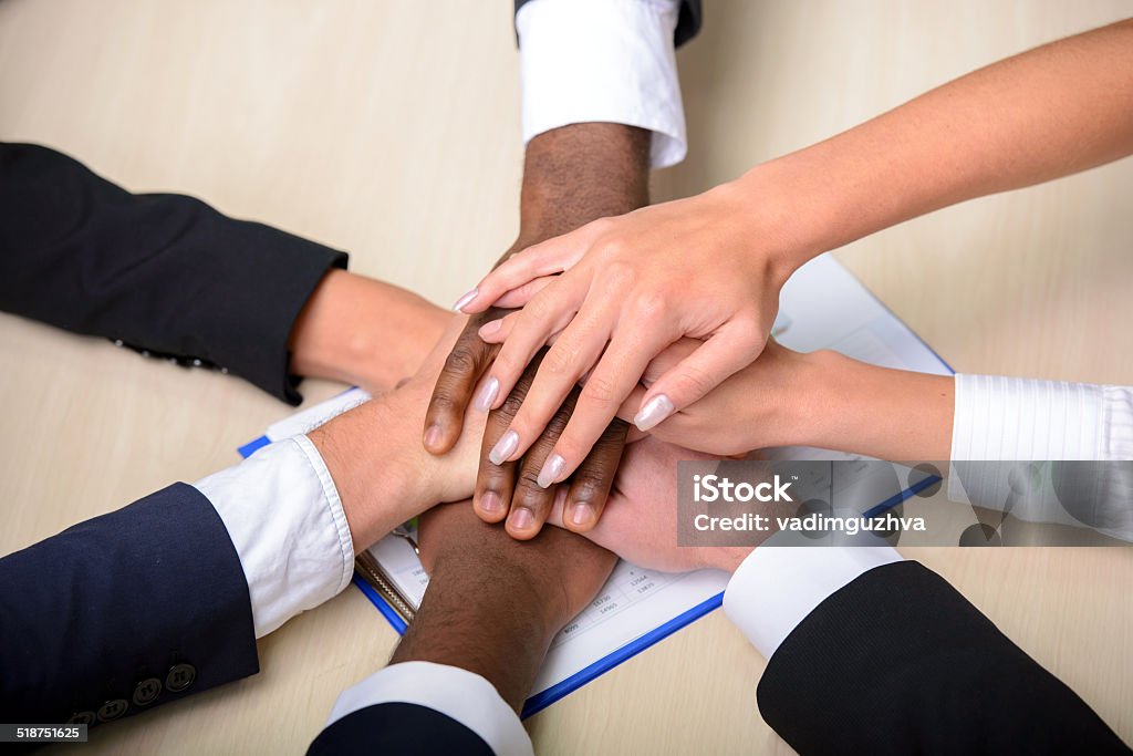 Business conference Celebrating victory. Group of business people joining hands. Achievement Stock Photo