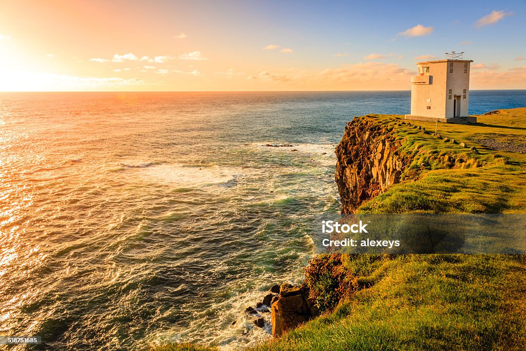 Lighthouse in Westfjords Lighthouse on Latrabjarg cliffs, the westmost point of Iceland Lighthouse Stock Photo