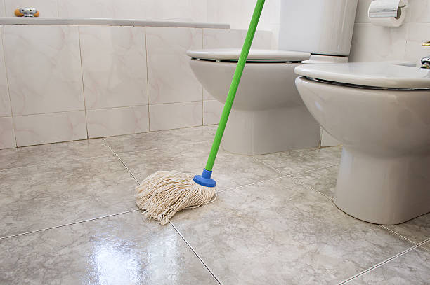 istock scrubbing bathroom with a mop gray 518751747