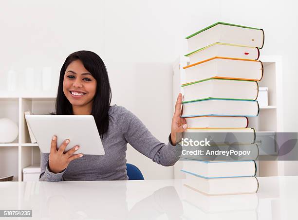 Woman Avoiding Books And Using Tablet Stock Photo - Download Image Now - Book, Stack, Digital Tablet