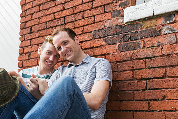 istock Gay men sitting on sidewalk 518754537