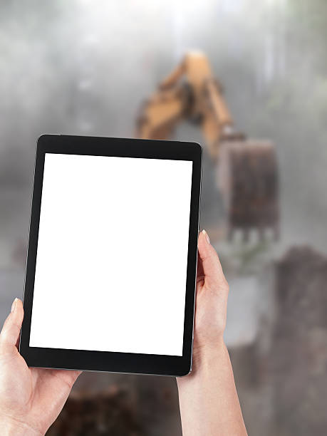 istock Tablet and excavator in the background 518754939