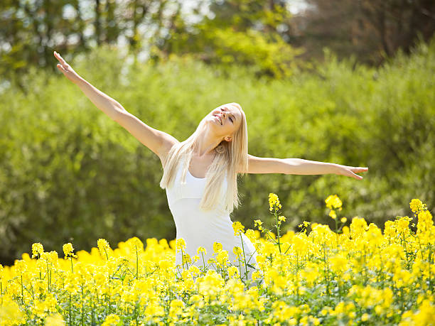 istock Young Woman Standing In Field 518755301