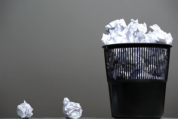 istock Recycle bin filled with crumpled papers 518756251