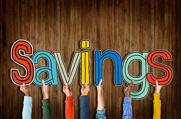 istock Multiethnic Group of Hands Holding Word Savings 518756347