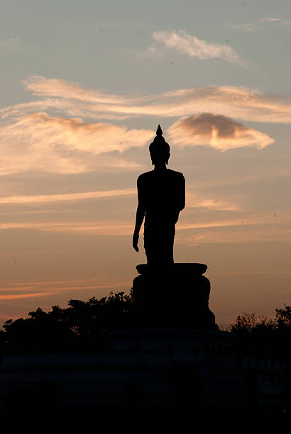 istock silhouette of big buddha statue with beautiful cloud 518756594