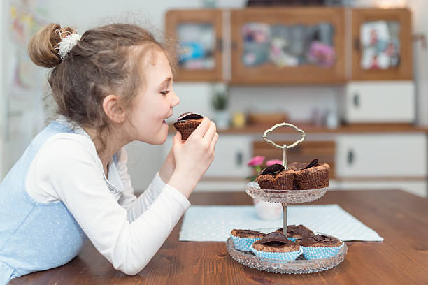 little girl eating cupcakes