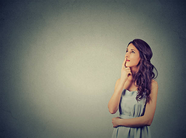 istock happy beautiful woman thinking looking up 518757094