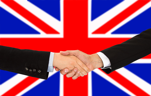 handshake of a woman and business men in UK