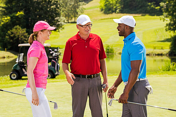 istock Golf Pro With Two Adult Golfers 518757557