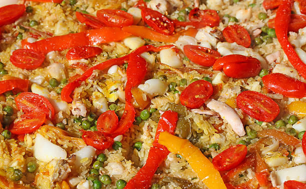 istock Rice paella with seafood, red tomatoes and peppers 518757661