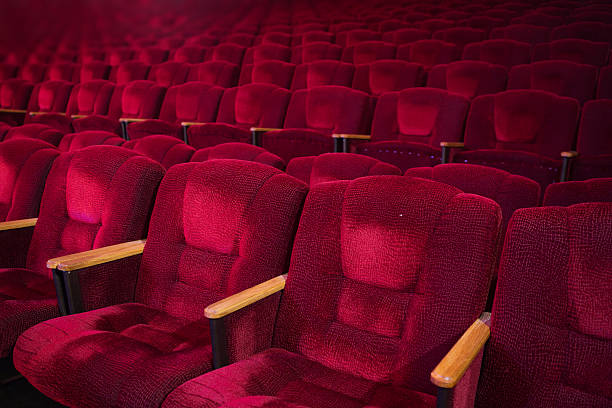 istock Red velvet armchairs in the empty auditorium 518758530