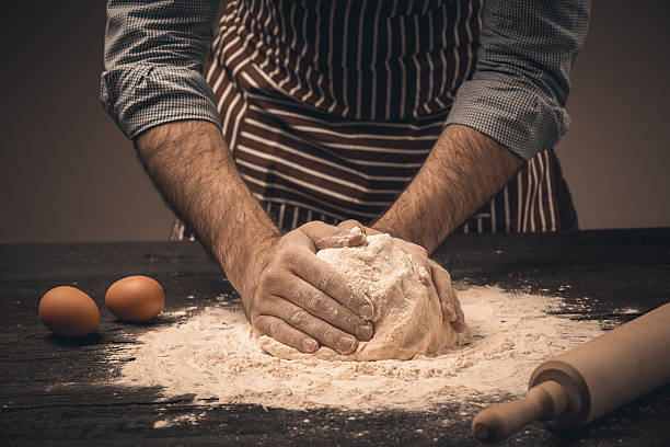 istock Male hands knead the dough. 518758532