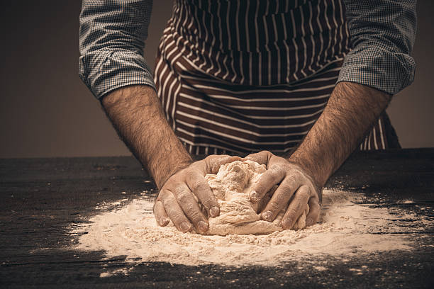 istock Male hands knead the dough. 518758608