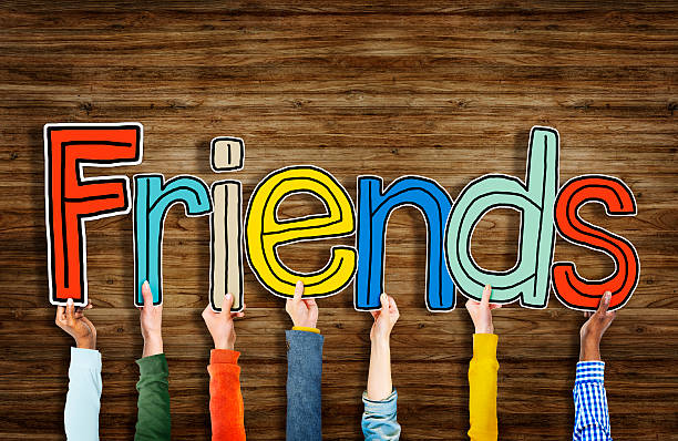 istock Multiethnic Group of Hands Holding Letter Friends 518758625