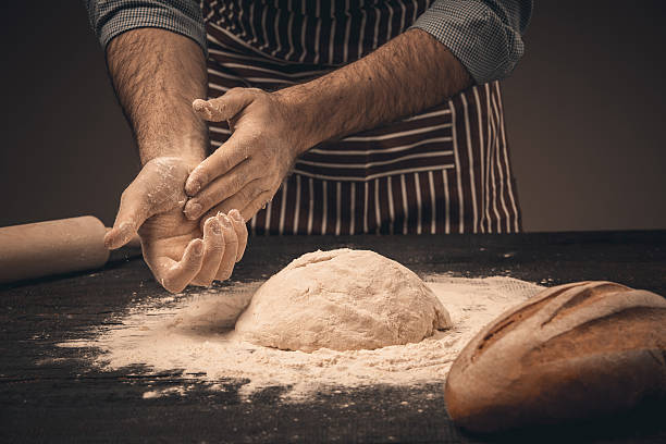 istock Male hands knead the dough. 518759102