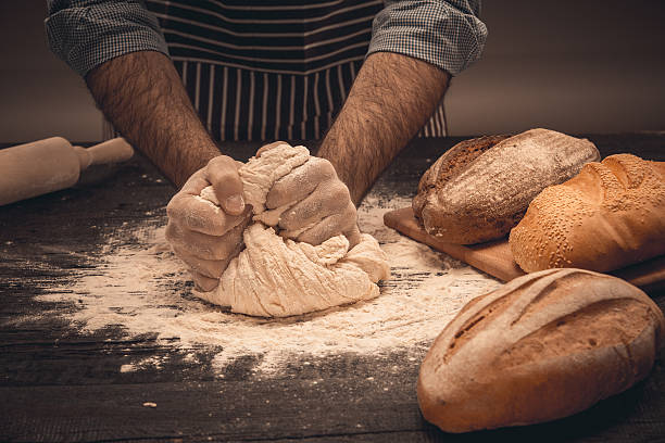 istock Male hands knead the dough. 518759450