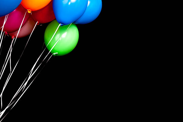 istock Colorful balloons over black wall background 518763170