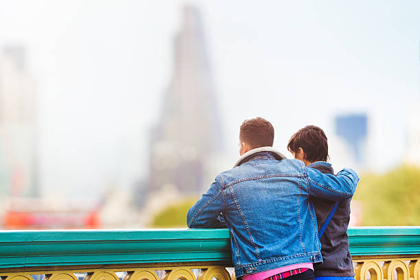 istock British couple looking at London Sunset by Thames 518763492