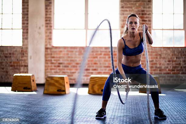 Athletic Girl Focused On Fitness Training With Ropes At Gym Stock Photo - Download Image Now