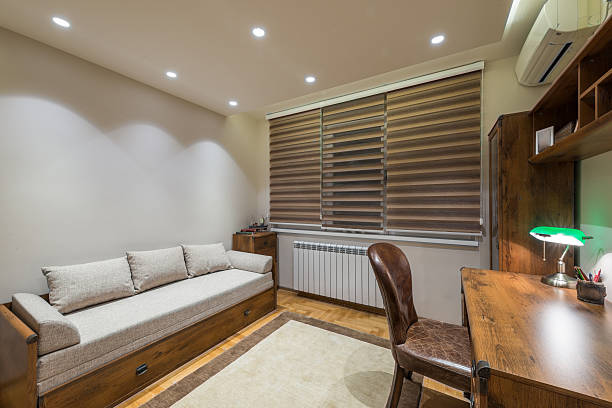istock Wooden desk and modrn sofa in apartment interior 518775638