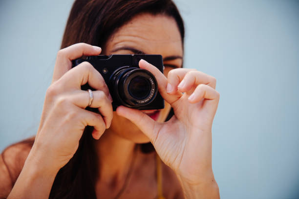 istock Middle-aged woman taking photos 518775686