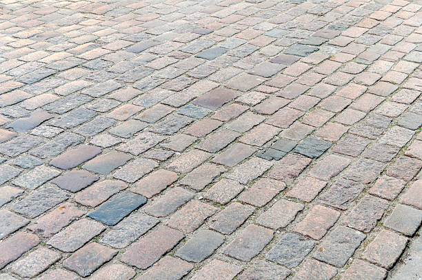 istock Abstract background of old cobblestone pavement close 518775856