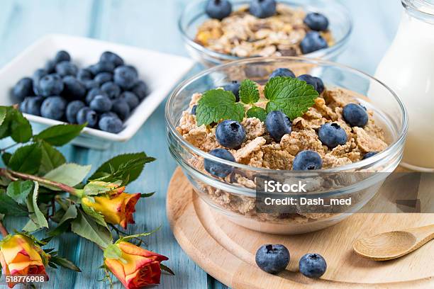 Breakfast With Cereal Blueberry Milk And Rose Flowers Stock Photo - Download Image Now