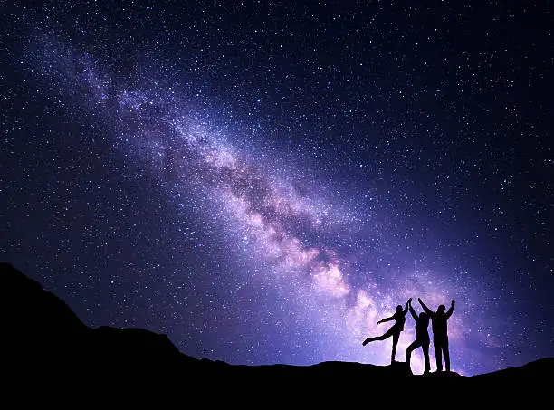 Photo of Landscape with Milky Way and silhouette of a happy family