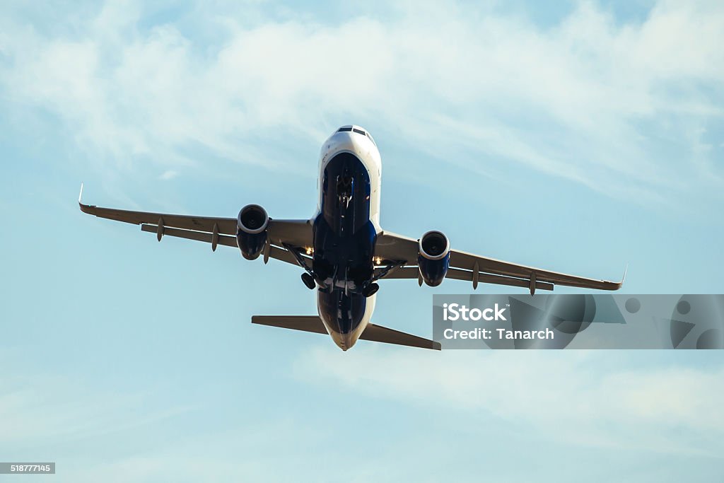 Air plane taking off. A Commercial air plane taking off, seen from below. Aerospace Industry Stock Photo