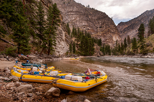 A row of rafts, beached for the night at a camp on the Middle Fork of the Salmon River, Idaho