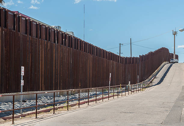Border fence separating Mexico and the United States Border fence in Nogales Arizona separating the United States from Nogales Sonora Mexico international border barrier stock pictures, royalty-free photos & images