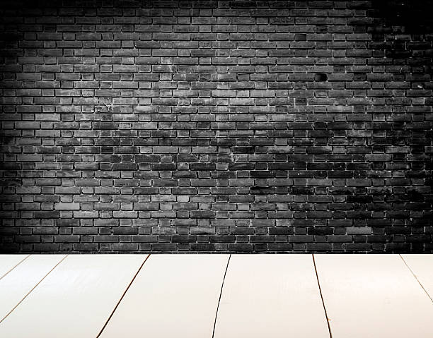 istock Grungy blac and white textured brick wall with white floor 518777596