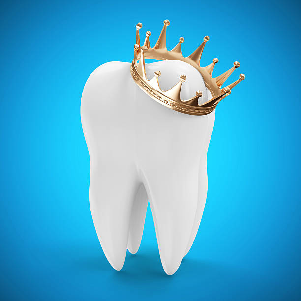 Tooth with Golden Crown on blue gradient background stock photo
