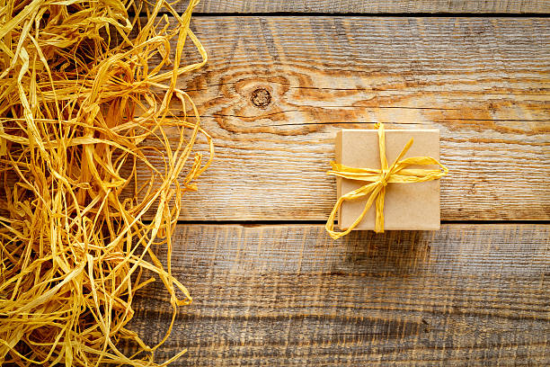 istock Craft gift box on wooden table with raffia or twine 518779368