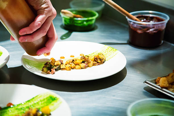 istock Chef dressing a vegetable dish with vinaigrette 518779757