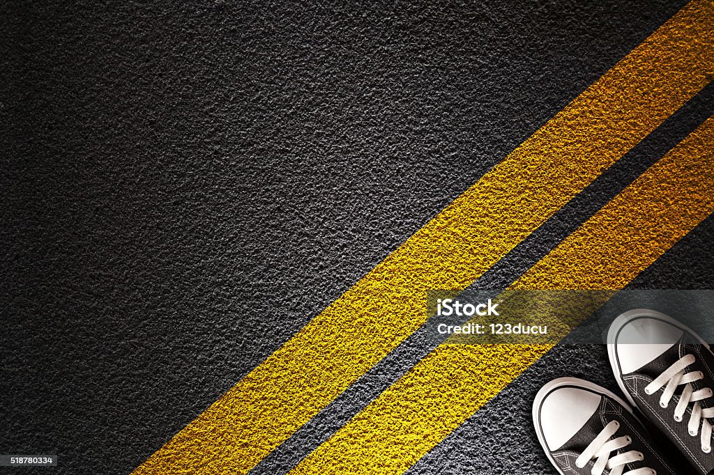 Man Standing on the yellow line Yellow line on the asphalt Boundary Stock Photo